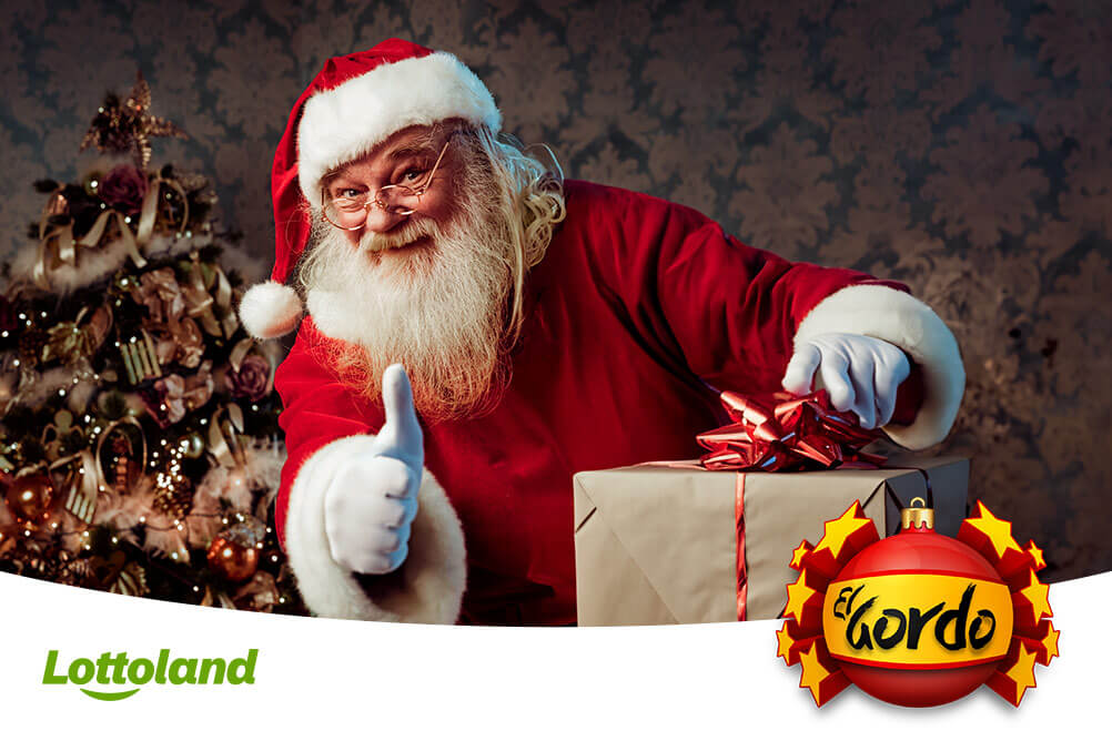 Bild zeigt den Lottoland Weihnachtsmann, der sich über die beliebtesten El Gordo Zahlen freut